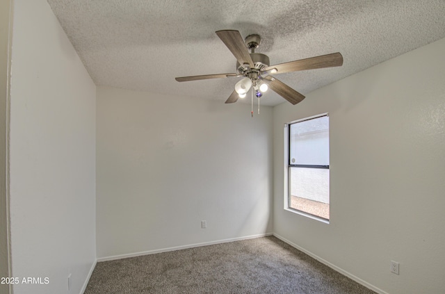 carpeted empty room with ceiling fan and a textured ceiling