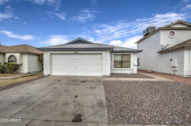 view of front of house featuring a garage and central AC unit