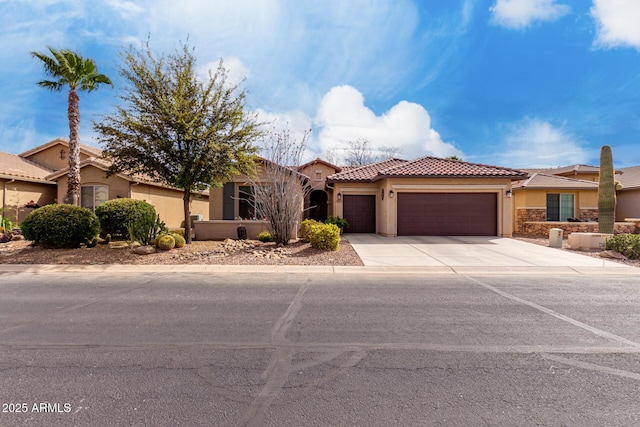 5083 W Buckskin Dr, Eloy, AZ 85131 - view of front of home with stucco siding, an attached garage, a tiled roof, and concrete driveway