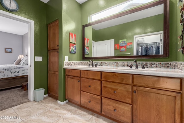 5083 W Buckskin Dr, Eloy, AZ 85131 - ensuite bathroom featuring double vanity, a sink, tasteful backsplash, and a textured wall
