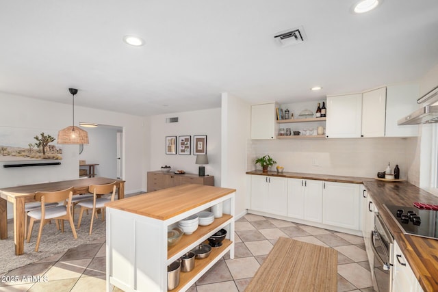 kitchen featuring open shelves, visible vents, white cabinets, and butcher block counters