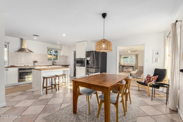 dining area featuring recessed lighting, visible vents, plenty of natural light, and light tile patterned flooring