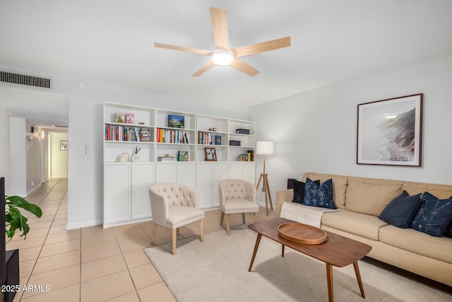 living room featuring light tile patterned flooring, baseboards, visible vents, and ceiling fan