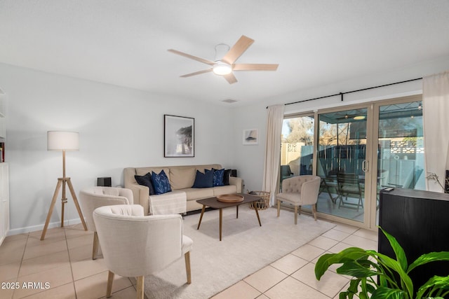 living room featuring light tile patterned flooring, visible vents, baseboards, and a ceiling fan