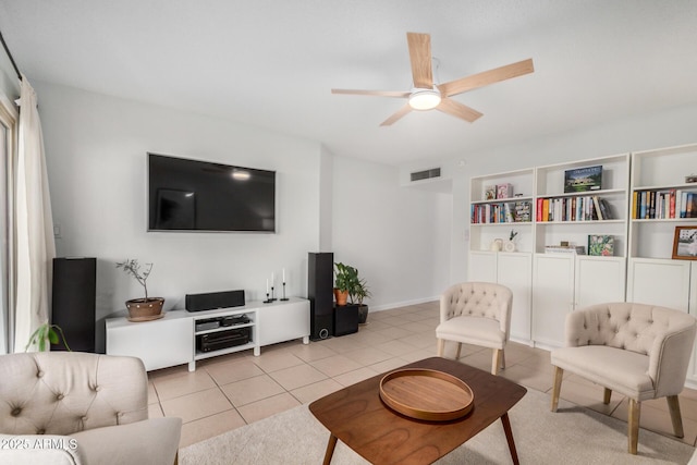 living area with light tile patterned floors, a ceiling fan, and visible vents