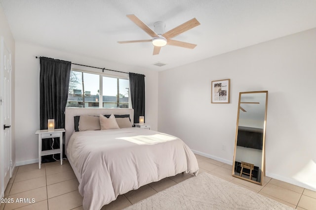 bedroom with light tile patterned floors, visible vents, a ceiling fan, and baseboards