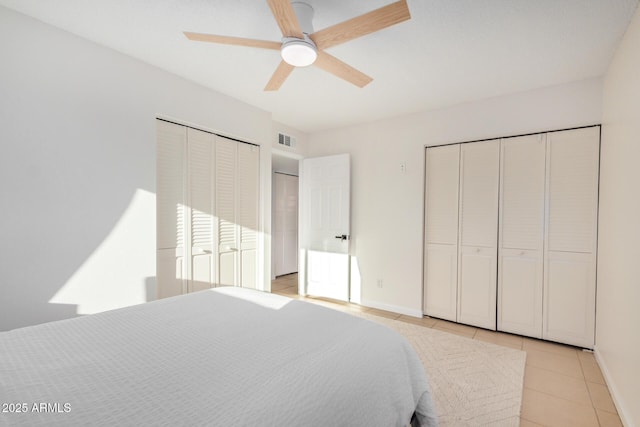 bedroom with light tile patterned flooring, baseboards, visible vents, and ceiling fan