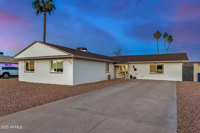 single story home with concrete block siding