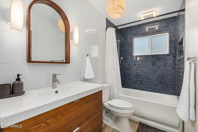 bathroom with vanity, toilet, and shower / tub combo with curtain