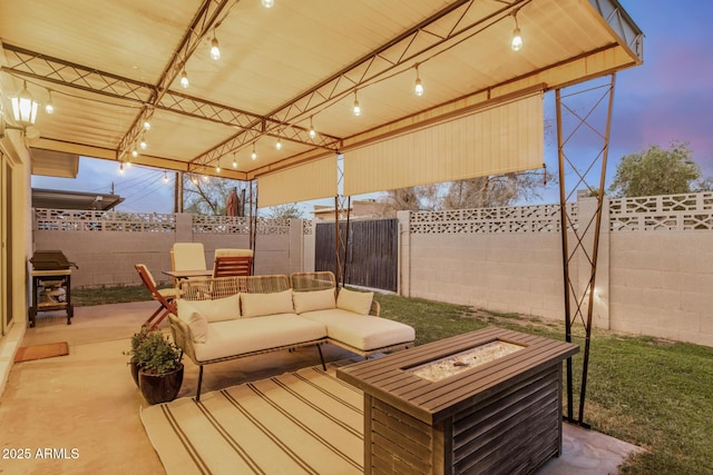 view of patio / terrace with an outdoor living space with a fire pit and a fenced backyard