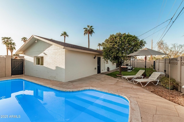 view of pool featuring a patio area, a fenced in pool, and a fenced backyard