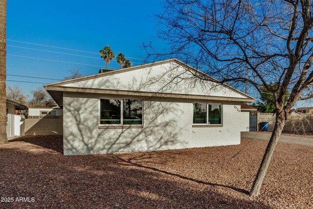 view of property exterior featuring fence