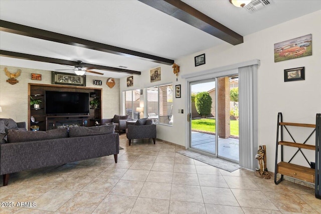 living room with light tile patterned flooring, ceiling fan, and beam ceiling