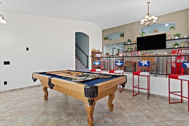 rec room with lofted ceiling, tile patterned flooring, pool table, and a chandelier