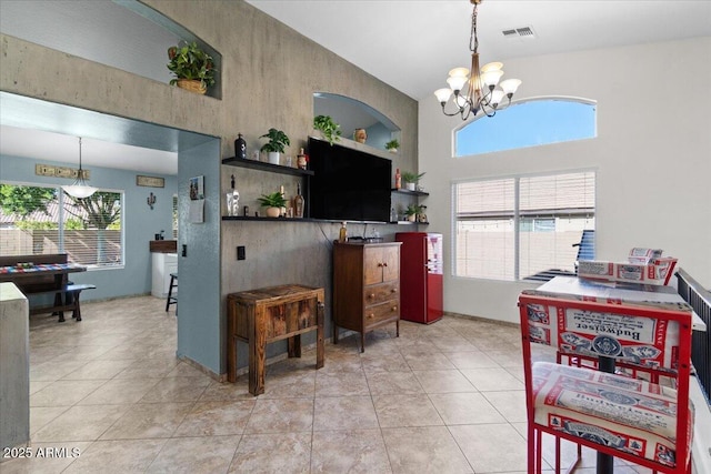 kitchen with hanging light fixtures, light tile patterned floors, and a chandelier