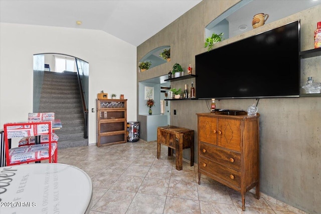 tiled living room featuring lofted ceiling