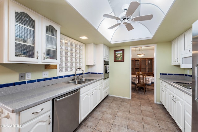 kitchen featuring sink, light tile patterned floors, ceiling fan, stainless steel appliances, and white cabinets