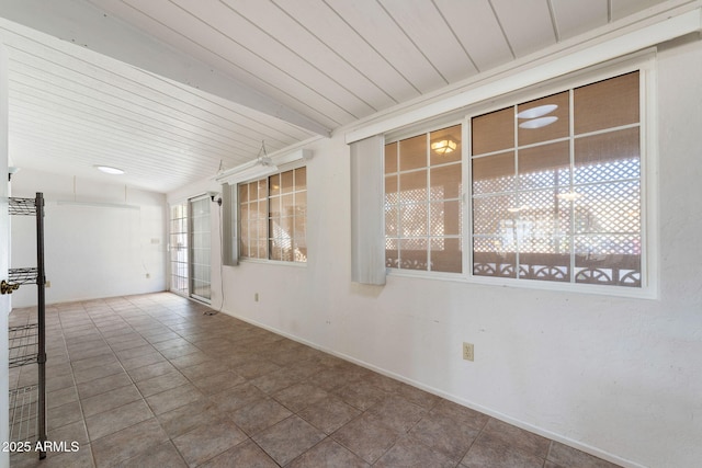 tiled spare room featuring wooden ceiling