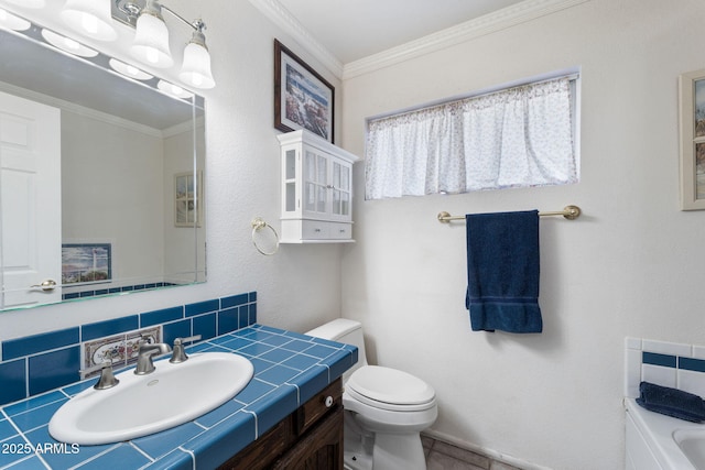 bathroom featuring tasteful backsplash, ornamental molding, vanity, and toilet