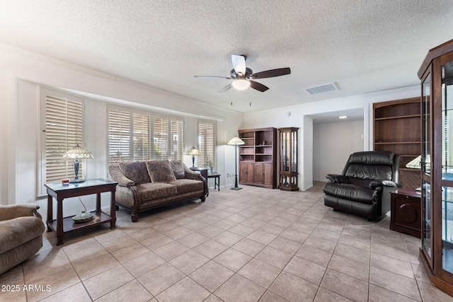 living room with light tile patterned flooring, a textured ceiling, and ceiling fan