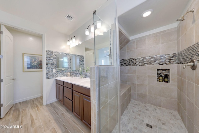 bathroom featuring a tile shower, hardwood / wood-style floors, and vanity