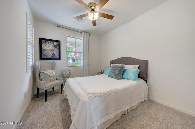 bedroom with light carpet and ceiling fan