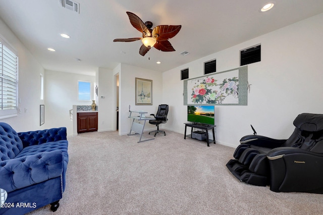 living room featuring ceiling fan and light colored carpet