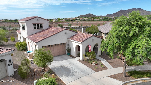 mediterranean / spanish home with a mountain view and a garage