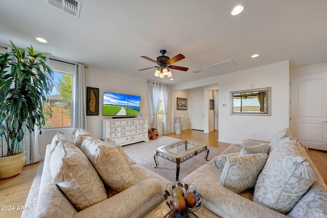 living room with ceiling fan and light hardwood / wood-style floors