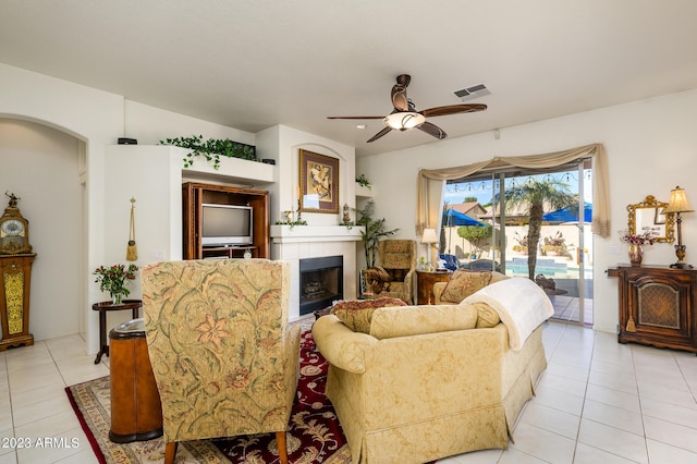 316 W Anderson Ave, Phoenix, AZ 85023 - living area with ceiling fan, light tile patterned flooring, a fireplace, and arched walkways