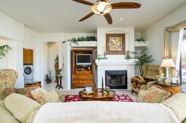316 W Anderson Ave, Phoenix, AZ 85023 - living room featuring washer / clothes dryer, ceiling fan, a fireplace, and arched walkways