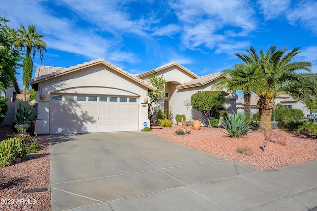 316 W Anderson Ave, Phoenix, AZ 85023 - view of front facade featuring concrete driveway, stucco siding, an attached garage, and a tile roof