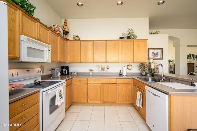 316 W Anderson Ave, Phoenix, AZ 85023 - kitchen featuring white appliances, a peninsula, light tile patterned flooring, recessed lighting, and arched walkways