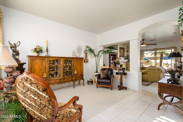 316 W Anderson Ave, Phoenix, AZ 85023 - living area with a ceiling fan, arched walkways, light colored carpet, and light tile patterned flooring