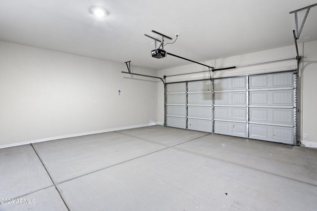 garage featuring baseboards and a garage door opener