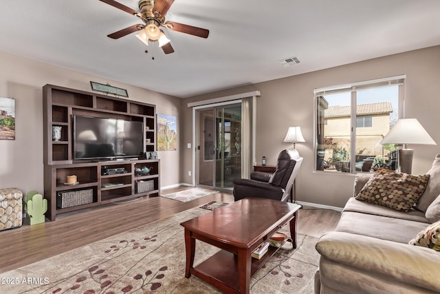 living room featuring ceiling fan and light wood-type flooring