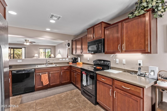 kitchen with black appliances, sink, light tile patterned floors, ceiling fan, and kitchen peninsula