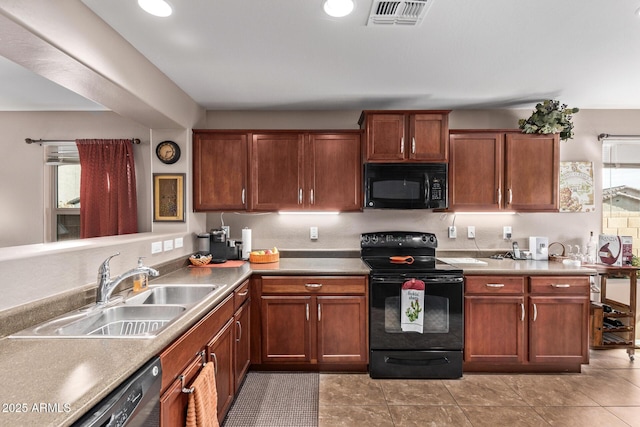 kitchen featuring light tile patterned floors, sink, and black appliances