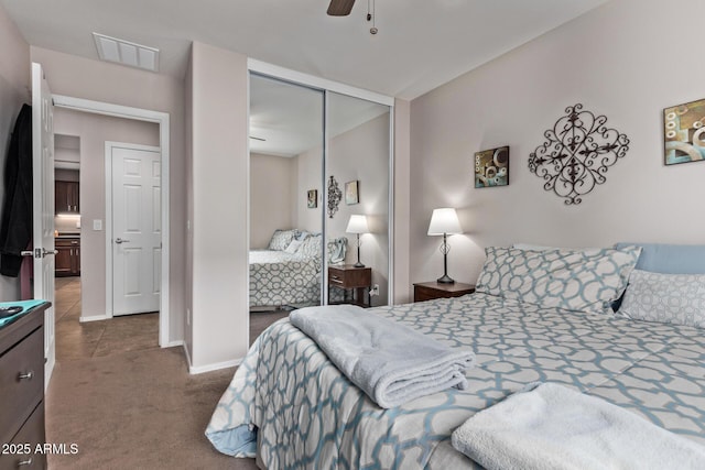 carpeted bedroom with a closet and ceiling fan