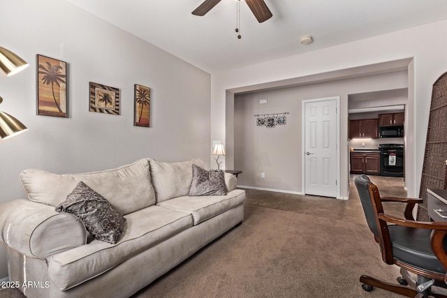 carpeted living room with ceiling fan