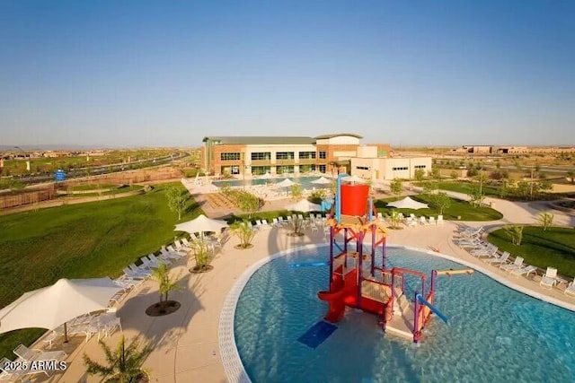 view of swimming pool with a playground