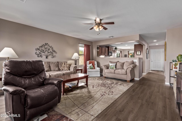 living room featuring dark hardwood / wood-style flooring and ceiling fan