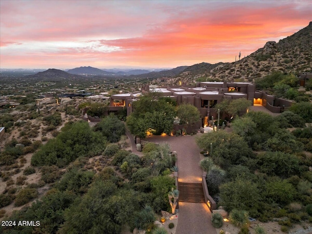 aerial view at dusk featuring a mountain view