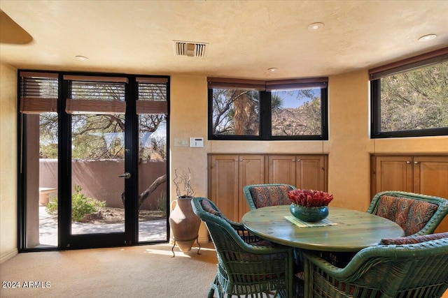 dining room with light colored carpet