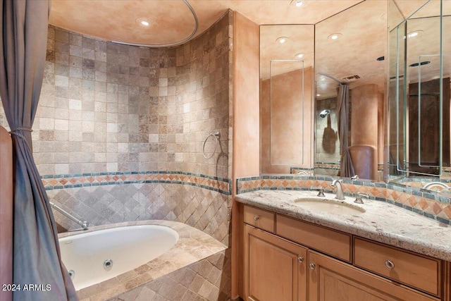 bathroom featuring tile walls, vanity, and plus walk in shower