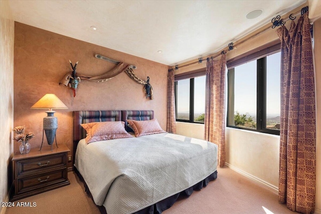 carpeted bedroom featuring multiple windows