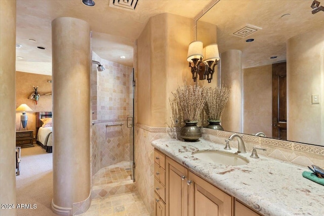 bathroom featuring vanity and a shower with shower door