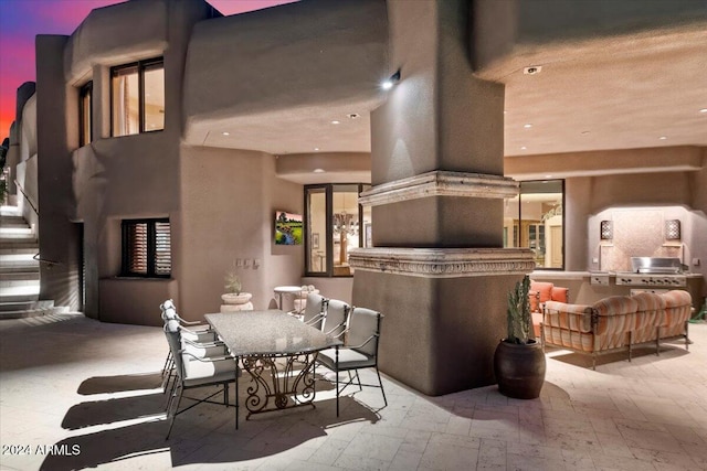 patio terrace at dusk with a fireplace