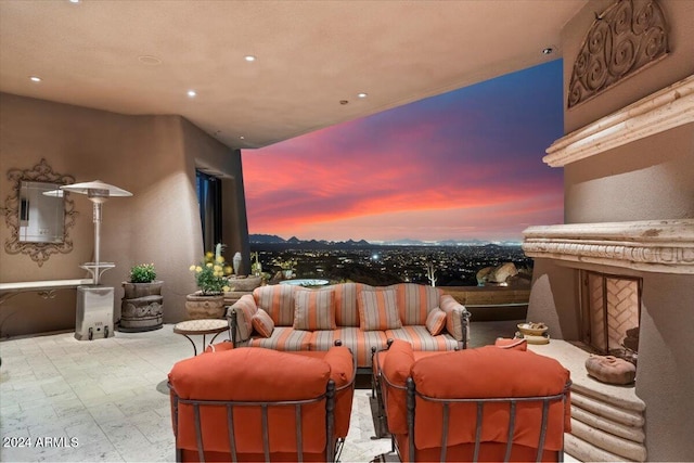 balcony at dusk featuring a patio and outdoor lounge area