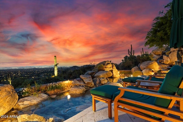 view of pool at dusk